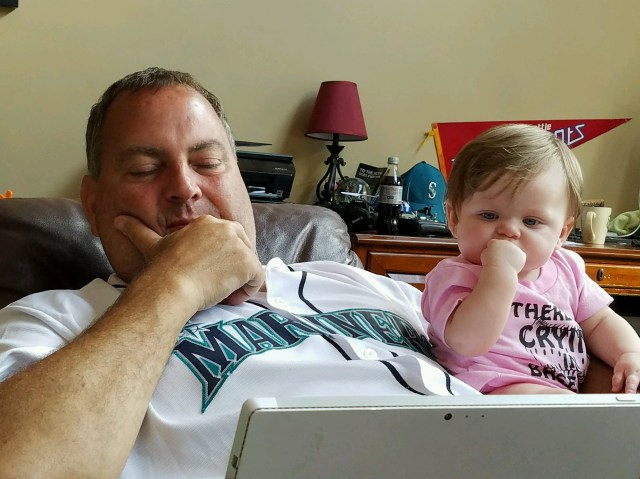 Scarlett and Papa getting ready to watch the Mariner game
